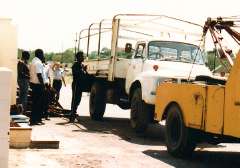 Ted (white shirt, left) supervises the unloading of equipment 